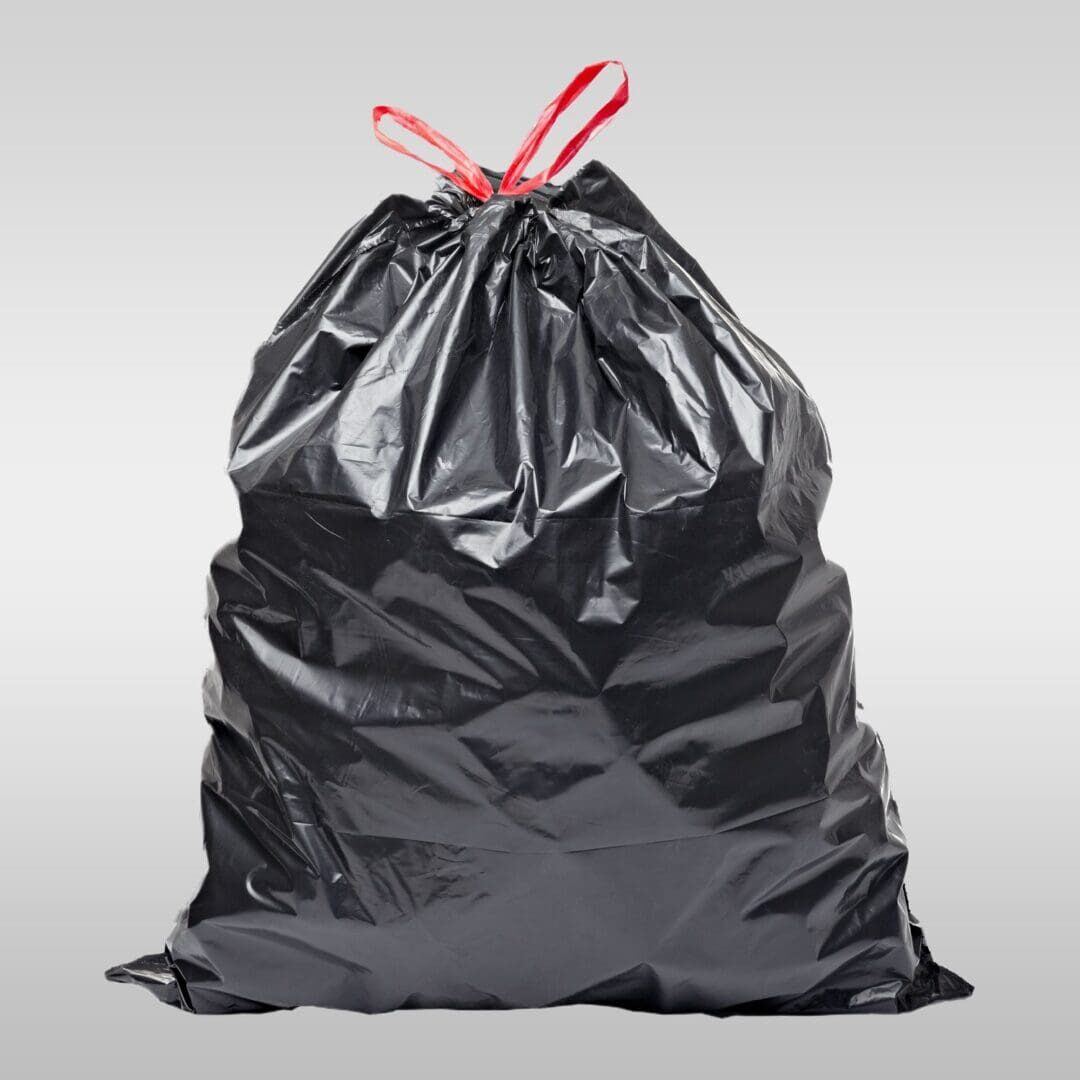 A black bag with red handles and a bow on it.