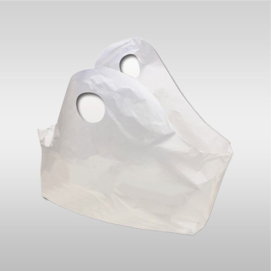 A white bag is sitting on top of the ground.